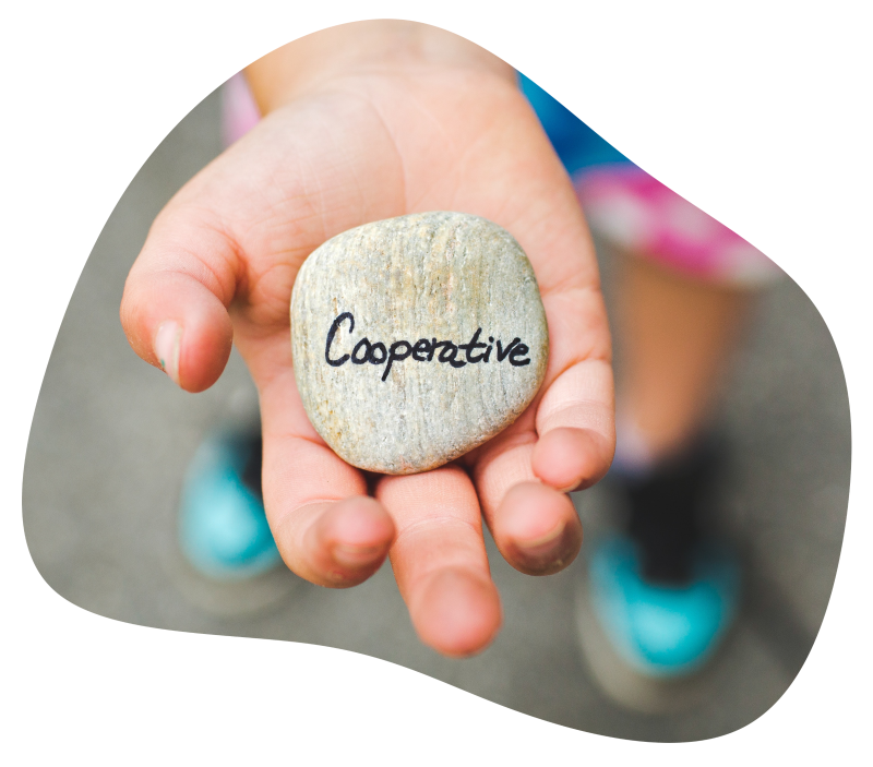 Pebble inscribed with the word 'Cooperative' in child's hand