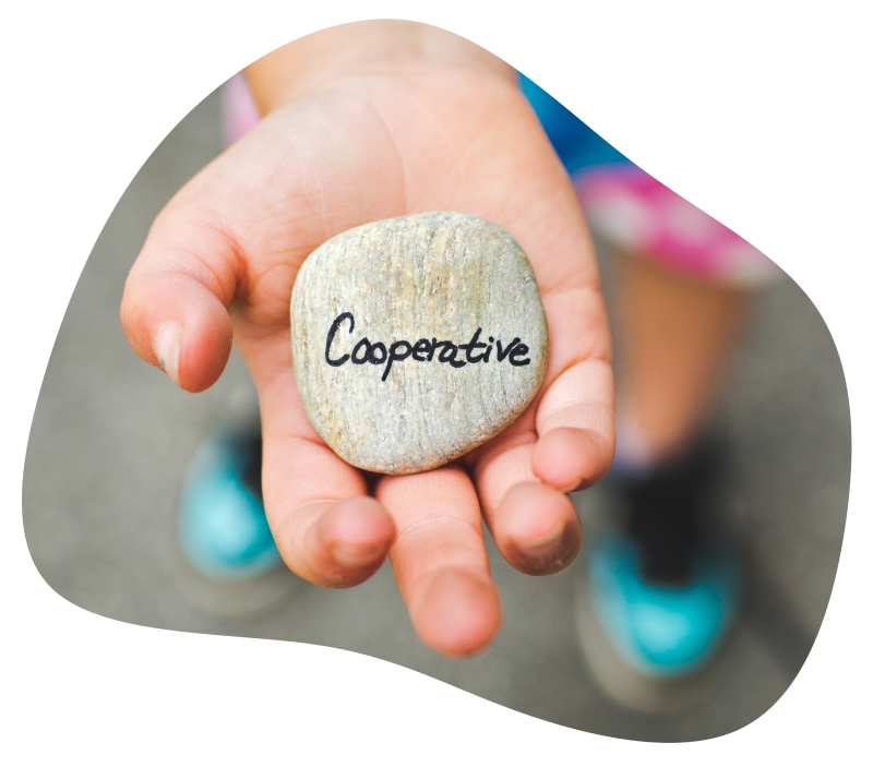 cooperate-blob Pebble inscribed with the word 'Cooperative' in child's hand